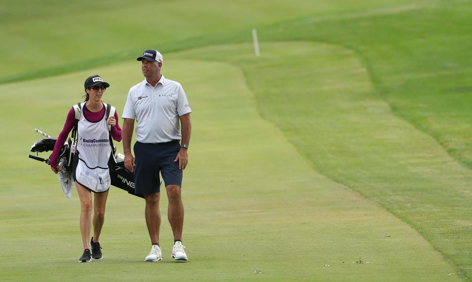 Stewart Cink, right, walks up the No. 16 fairway Wednesday with his wife and caddie, Lisa, during the 2023 Kaulig Companies Championship Pro-Am at Firestone Country Club in Akron.