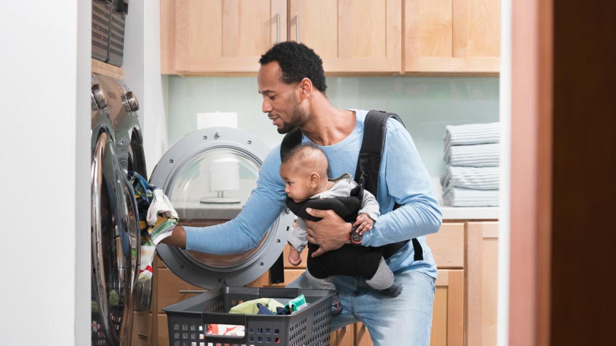 Father and baby doing laundry