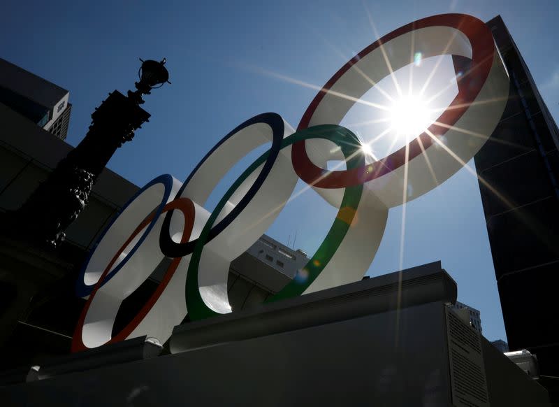 FILE PHOTO: Summer sunshine is seen through Olympic rings displayed at Nihonbashi district in Tokyo, Japan