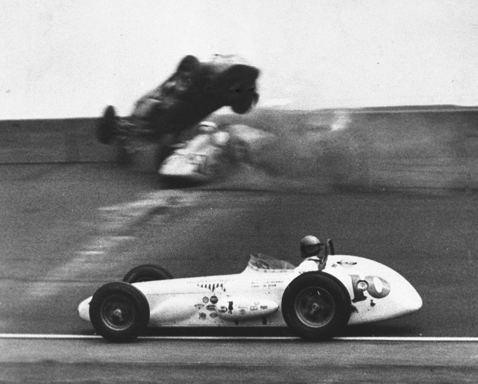 FILE - A.J. Foyt (10) passes a crash between drivers Mike Magill, top, and Chuck Weyant during the 43rd running of the Indianapolis 500 auto race at Indianapolis Motor Speedway in Indianapolis, Ind., on May 30, 1959. (AP Photo/File)
