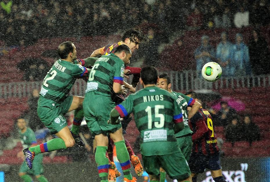 FC Barcelona's Carles Puyol, third left, jumps for the ball to scores Elche during a Copa del Rey soccer match at the Camp Nou stadium in Barcelona, Spain, Wednesday, Jan. 29, 2014. (AP Photo/Manu Fernandez)