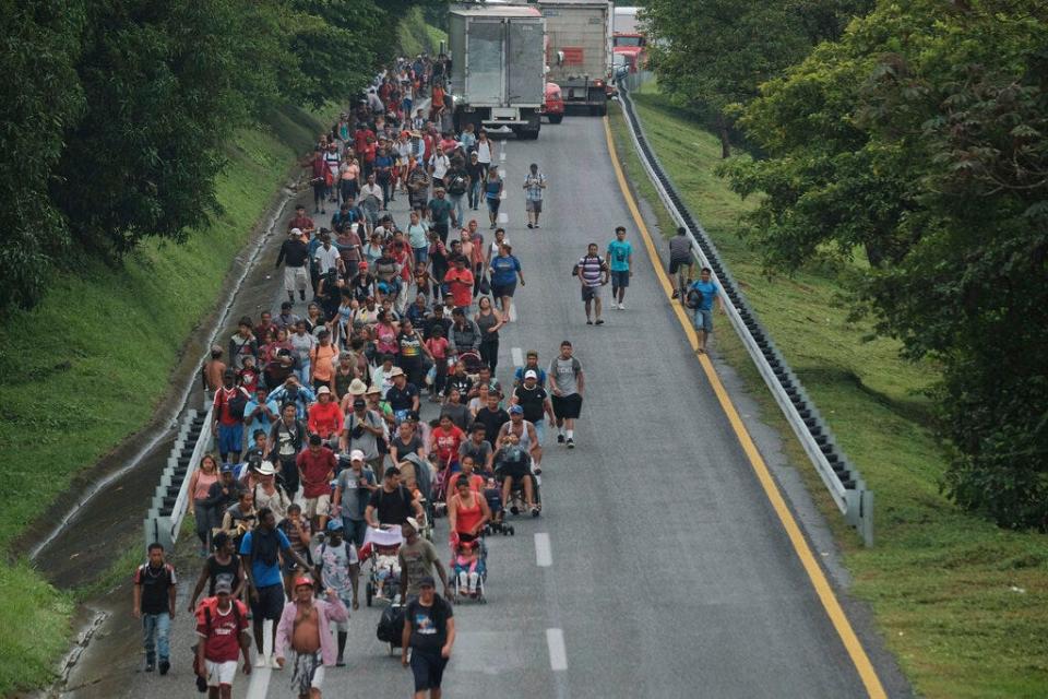 Migrants leave Ulapa, Chiapas state, late Saturday, Oct. 30, 2021. The migrant caravan heading north in southern Mexico has so far been allowed to walk unimpeded, a change from the Mexican government's reaction to other attempted mass migrations. (AP Photo/Isabel Mateos)