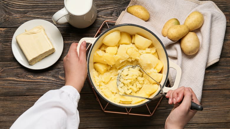 person making mashed potatoes