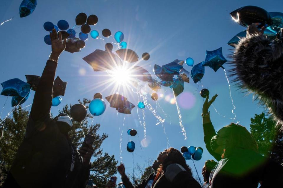 Friends and family of Corri Howard, a man who was found dead in a marsh following a police chase, release balloons in his honor at a park in Moss Point on Monday, Jan. 17, 2022.