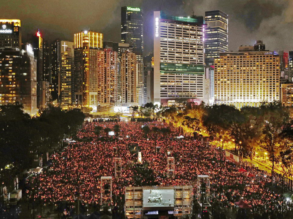 FILE - In this June 4, 2019, file photo, thousands of people attend a candlelight vigil in Hong Kong's Victoria Park to mark the anniversary of the military crackdown on a pro-democracy student movement in Beijing. (AP Photo/Vincent Yu, File)