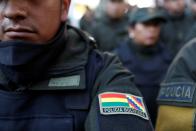 A badge with the Wiphala and Bolivian flags is seen in the uniform of a policeman during a ceremony at the General Command of the police in La Paz