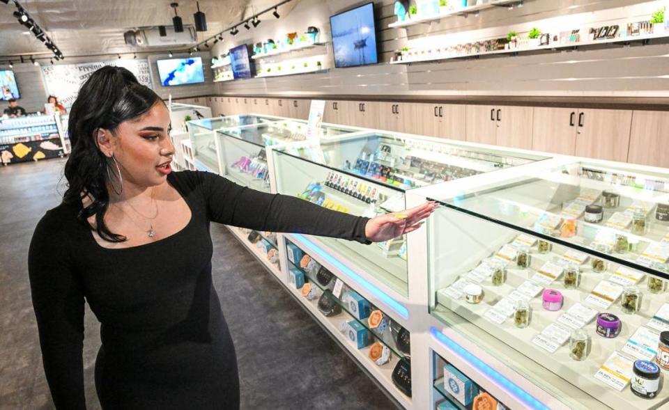 Jenny Venegas , district sales manager for Haven Cannabis Dispensary, points out some of the products in the showroom of their new location in downtown Fresno on Tuesday, April 16, 2024.