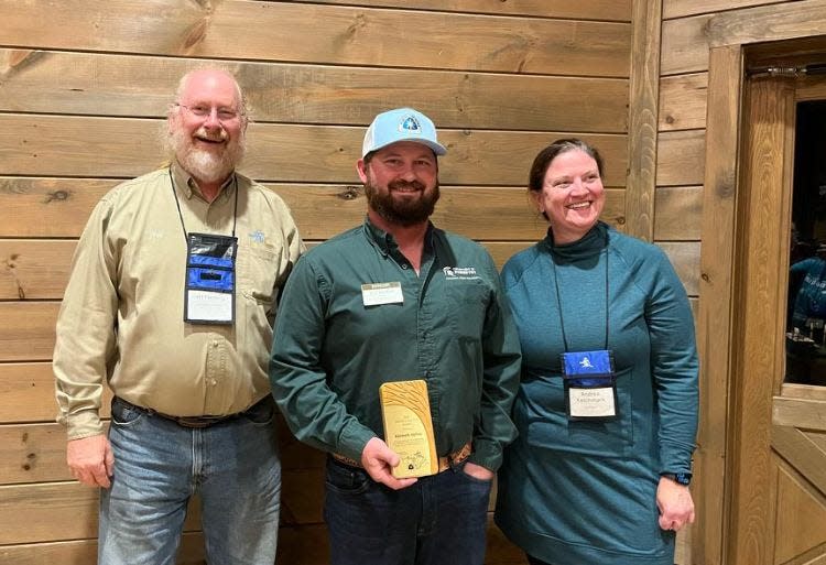 Kenneth KJ Kettler, manager of the W.K. Kellogg Experimental Forest in Augusta, has received the Friend of the Trail award from the North Country Trail Association. Kettler, center, smiles for a photo with Jeff Fleming, Chief Noonday Chapter of the NCTA member, and Andrea Ketchmark, executive director at North Country Trail Association.