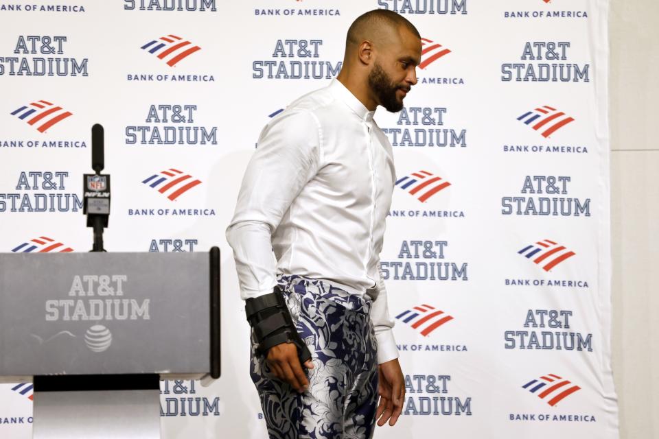 Dallas Cowboys quarterback Dak Prescott, wearing a brace on his right hand, walks away from the podium after a post game news conference followinf the team's 19-3 loss to the Tampa Bay Buccaneers in a NFL football game in Arlington, Texas, Sunday, Sept. 11, 2022. (AP Photo/Ron Jenkins)