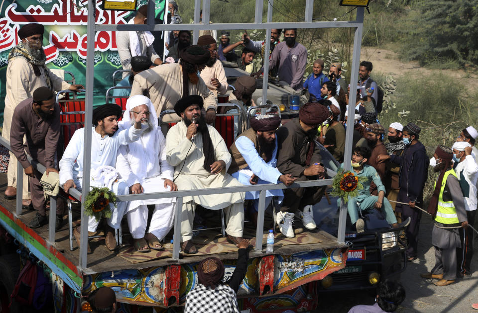 Leaders of Tehreek-e-Labiak Pakistan, a radical Islamist party, rally a protest march toward Islamabad, on a highway in the town of Sadhuke, in eastern Pakistan, Wednesday, Oct. 27, 2021. Violence at the anti-France Islamist rally in Sadhuke left at least one police officer and two demonstrators dead. ​They demanded the expulsion of France's envoy to Pakistan over publication of caricatures of Islam's Prophet Muhammad in France. (AP Photo/K.M. Chaudary)