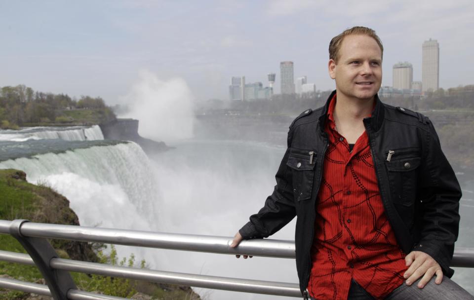 Nik Wallenda poses for photos after a news conference in Niagara Falls, N.Y., Wednesday, May 2, 2012. Wallenda will try to cross the Niagara Gorge on a tightrope June 15. The seventh-generation member of the Flying Wallendas spent months getting the necessary permissions from Canada and the United States for the cross-border stunt. (AP Photo/David Duprey)