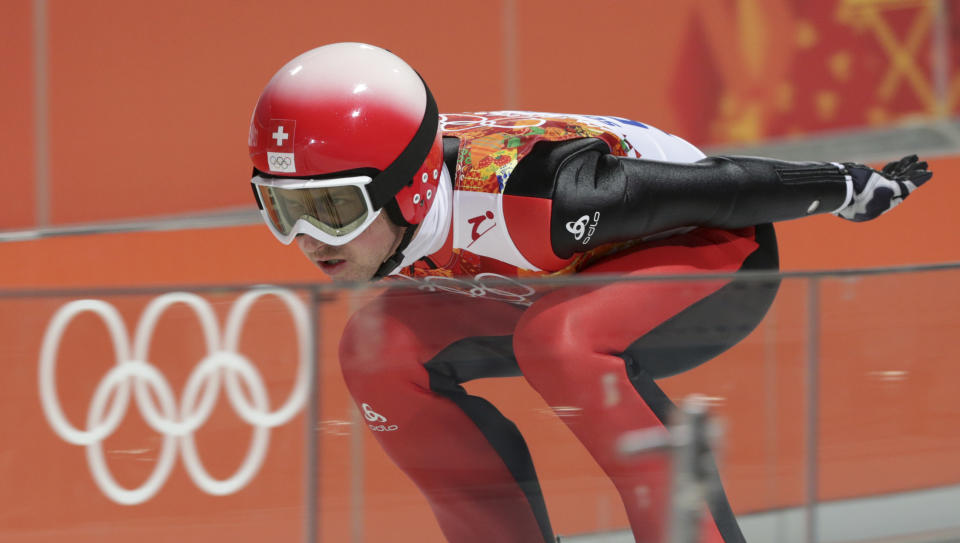 Switzerland's Simon Ammann starts an attempt during the men's normal hill ski jumping qualification at the 2014 Winter Olympics, Saturday, Feb. 8, 2014, in Krasnaya Polyana, Russia. (AP Photo/Matthias Schrader)