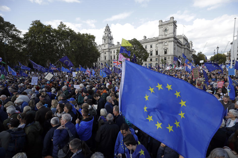 Anti-Brexit remain in the European Union supporters gather after taking part in a "People's Vote" protest march calling for another referendum on Britain's EU membership, in Parliament Square in London, Saturday, Oct. 19, 2019. Britain's Parliament is set to vote in a rare Saturday sitting on Prime Minister Boris Johnson's new deal with the European Union, a decisive moment in the prolonged bid to end the Brexit stalemate. Various scenarios may be put in motion by the vote. (AP Photo/Matt Dunham)