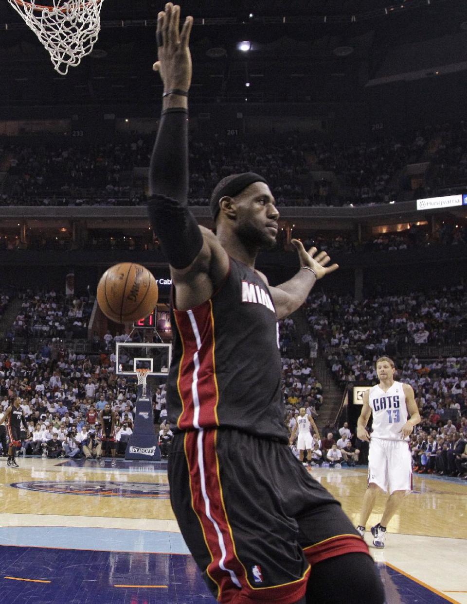 Miami Heat's LeBron James gestures after dunking against the Charlotte Bobcats during the first half in Game 4 of an opening-round NBA basketball playoff series in Charlotte, N.C., Monday, April 28, 2014. (AP Photo/Chuck Burton)