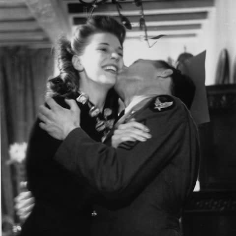 A couple kiss under the mistletoe in 1942 - Credit: Hulton Archive