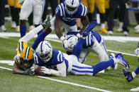 Indianapolis Colts' DeForest Buckner (99) recovers a fumble by Green Bay Packers' Marquez Valdes-Scantling, left, during overtime of an NFL football game, Sunday, Nov. 22, 2020, in Indianapolis. (AP Photo/Michael Conroy)