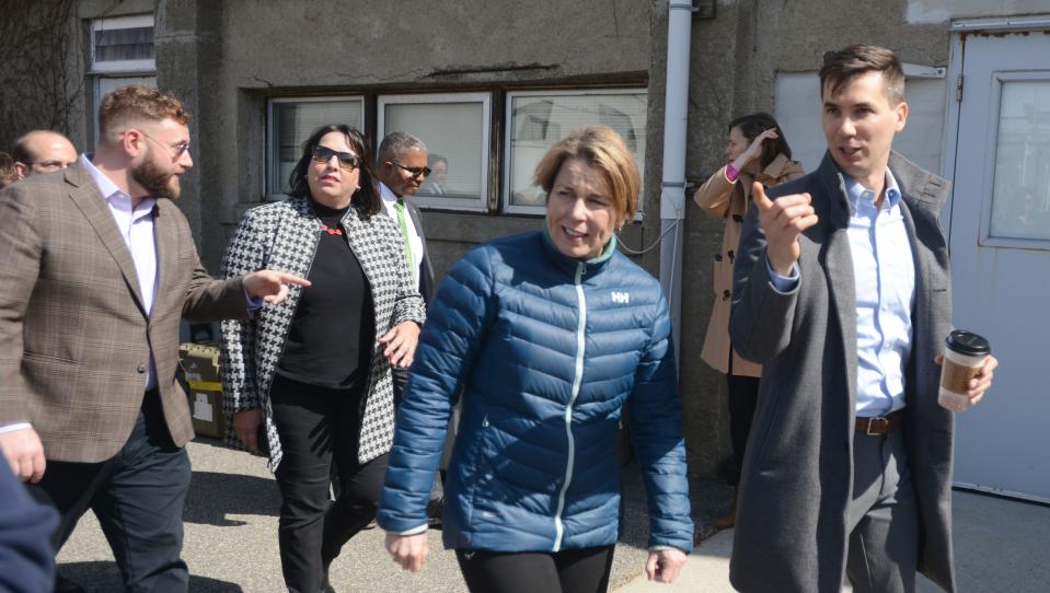 Massachusetts Gov. Maura Healey (center) chats with state Rep Dylan Fernandes, D-Woods Hole, and Lt. Gov. Kim Driscoll with state Sen. Julian Cyr, D-Truro, left, during a tour on Thursday of the docks at the Woods Hole Oceanographic Institute in Woods Hole.