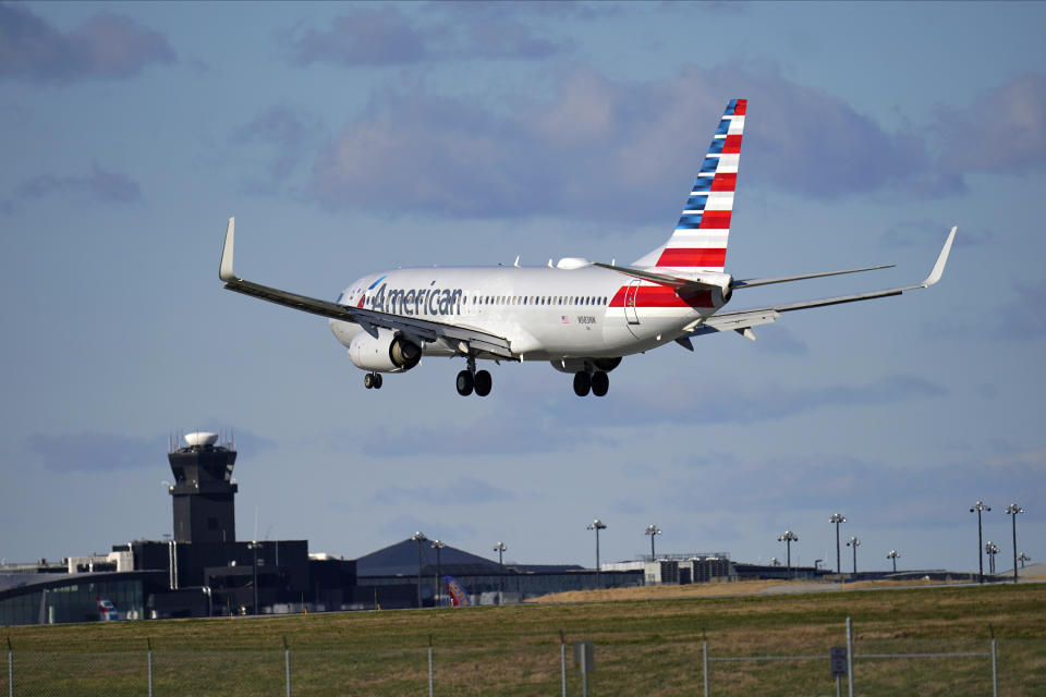 An American Airlines flight from Dallas-Fort Worth International Airport makes its landing approach onto Baltimore-Washington International Thurgood Marshall Airport, Monday, Nov. 23, 2020, in Glen Burnie, Md. (AP Photo/Julio Cortez)