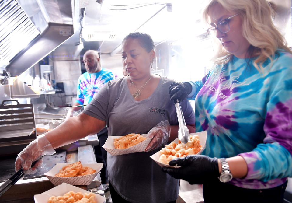 Aspen Street Sweets owners Ryan and Natalie Smith will open a second AJ's Street Kravz food truck in March.  The team of Ryan Smith, far left, Tina Evans, center, and Natalie Smith work to prepare orders.