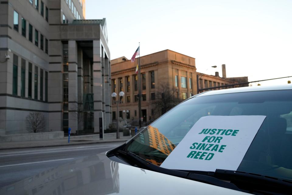 A sign calling for justice for Sinzae Reed is seen in a car Saturday during a protest outside of Columbus Police Headquarters for Sinzae Reed, 13, who was shot and killed Oct. 12.