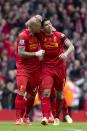 Liverpool's Martin Skrtel, left, celebrates with teammate Luis Suarez after their team beats Manchester City 3-2 in their English Premier League soccer match at Anfield Stadium, Liverpool, England, Sunday April 13, 2014. (AP Photo/Jon Super)