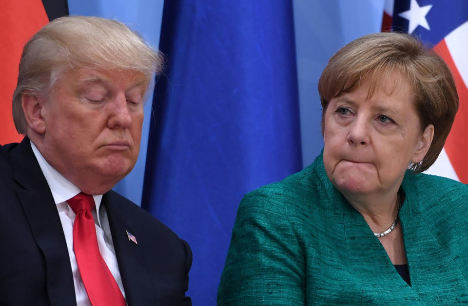 Donald Trump and Angela Merkel attend an event