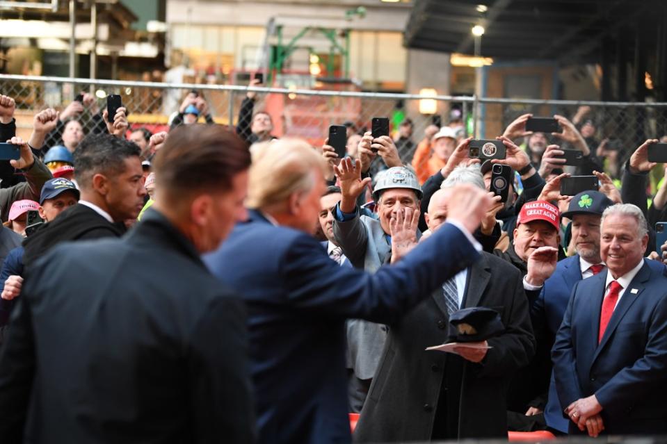 People react as Republican presidential candidate and former President Donald Trump meets with union workers. Matthew McDermott