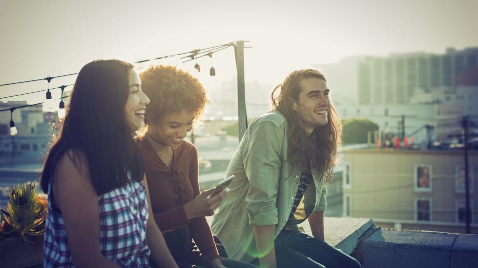 friends sharing a laugh on urban rooftop