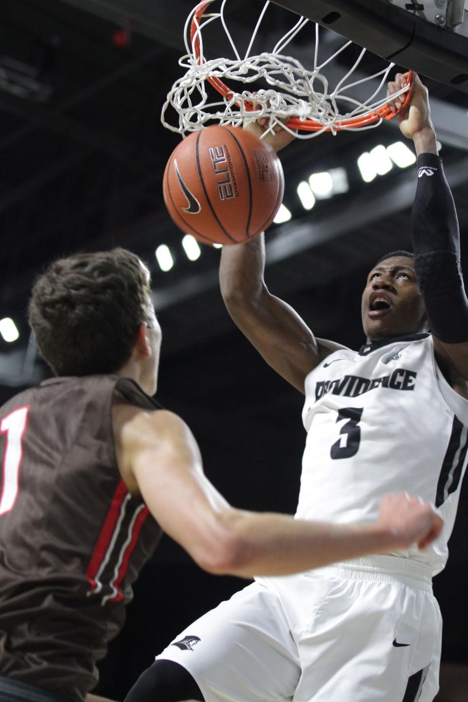 PC's Kris Dunn dunks the ball as Brown's Travis Fuller is late to cover during a game in 2015. The two teams will play each other in December after a long hiatus.