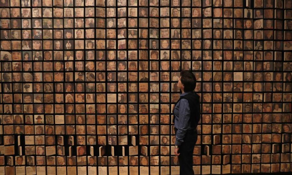 Jo Loosemore, curator of the Mayflower 400 exhibition in Plymouth, with photographs of people who can claim to be descendants of the original passengers, and of the Native American Mashpee Wampanoag tribe.