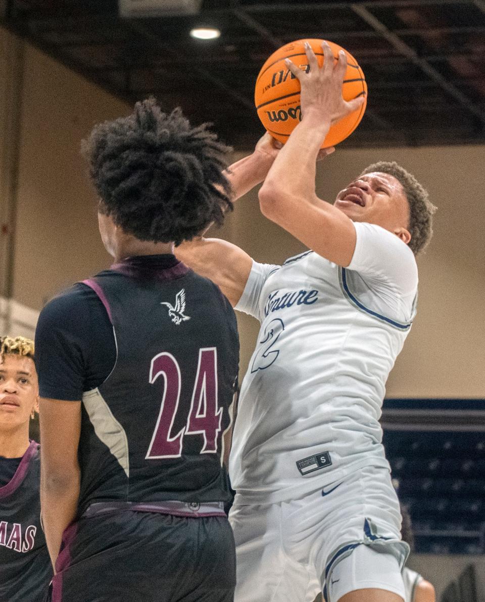 Venture Academy's Mario Williams., right, goes to the hoop against Natomas's Achilles Terrell during the Sac-Joaquin Section Div. 4 boys basketball championship game at U.C. Davis' University Credit Union Center in Davis on Feb. 23, 2024. Venture Academy won 78-74.