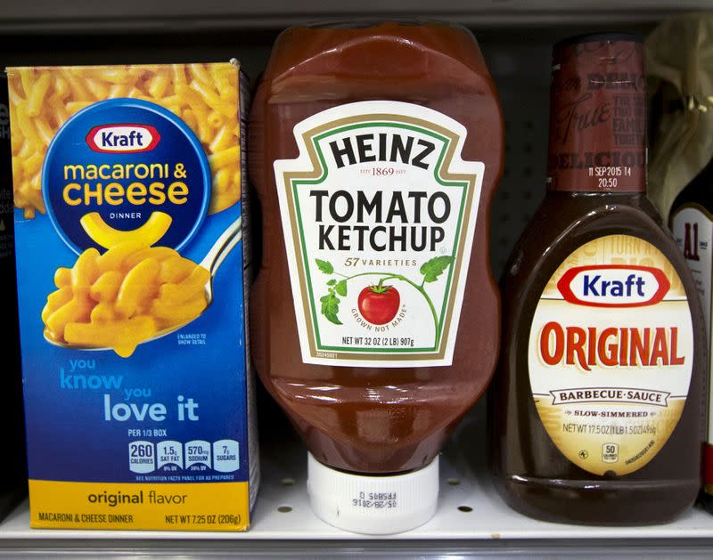 FILE PHOTO: A Heinz Ketchup bottle sits between a box of Kraft macaroni and cheese and a bottle of Kraft Original Barbecue Sauce on a grocery store shelf in New York