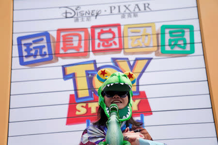 A woman attends the opening event of Disney-Pixar Toy Story Land, the seventh themed land in Shanghai Disneyland in Shanghai, China April 26, 2018. REUTERS/Aly Song