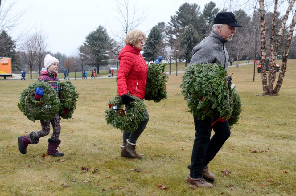 Volunteers head out into Greenwood Cemetery in Petoskey with wreaths to place on veterans' graves on Saturday, Dec. 16, 2023 for the annual Wreaths Across America event.