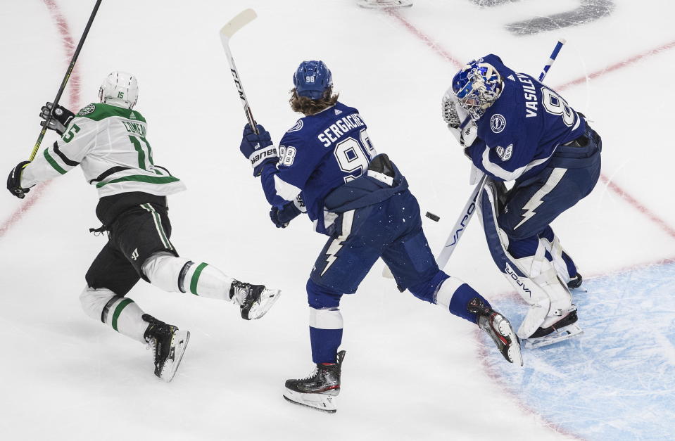 Dallas Stars left wing Blake Comeau (15) and Tampa Bay Lightning defenseman Mikhail Sergachev (98) battle as Lightning goaltender Andrei Vasilevskiy (88) makes a save during first-period NHL Stanley Cup finals hockey action in Edmonton, Alberta, Saturday, Sept. 19, 2020. (Jason Franson/The Canadian Press via AP)