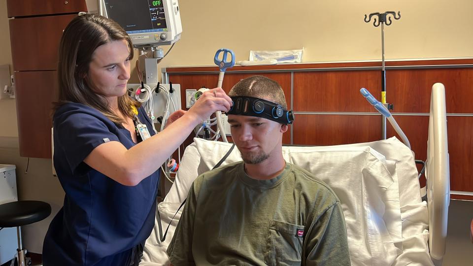 Matthew Hallahan's nurse Emily Durham demonstrates how she can put on the Ceribell headband device quickly to diagnose and monitor his seizures using AI.
