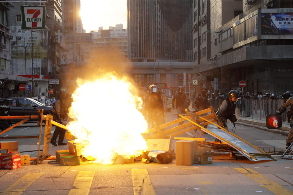 Protestors make fire to block traffic in Hong Kong, Sunday, Oct. 20, 2019. Hong Kong protesters again flooded streets on Sunday, ignoring a police ban on the rally and setting up barricades amid tear gas and firebombs. (AP Photo/Kin Cheung)