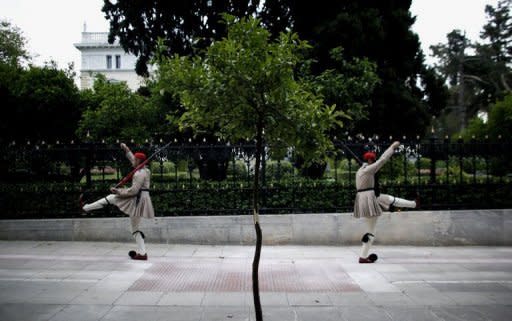 Greek presidential guards march in front of the Maximou presidential mansion in Athens. Greece's president called Monday for talks on a technocrat government, seeking to resolve the crisis over a tough EU-IMF debt bailout which risks forcing the country into new elections and out of the eurozone