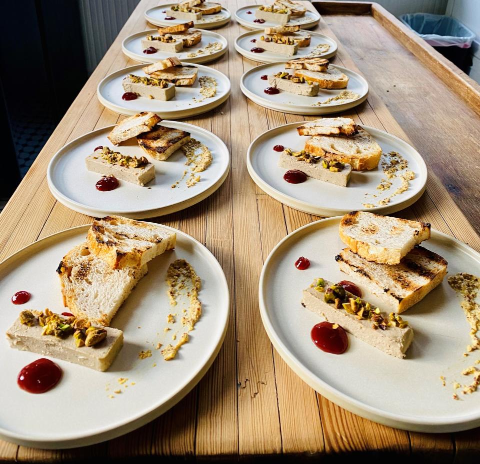 Jake Timms cooks all the food for The Community Table's four-course dinners, including dishes like chicken liver mousse with whole grain mustard, spiced pickled cherries, pistachios and grilled sourdough.