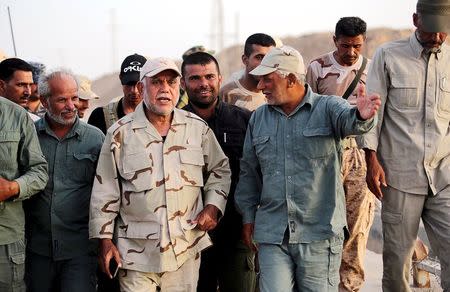 Head of the Badr Organisation and Shi'ite paramilitary commander Hadi al-Amiri (C) walks with Shi'ite fighters at Lake Tharthar, west of Samarra, Iraq in this June 6, 2015 file photo. REUTERS/Stringer/Files