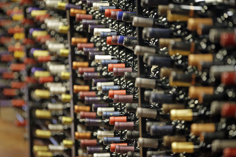 FILE - In this June 16, 2016, file photo, bottles of wine are displayed during a tour of a state liquor store, in Salt Lake City. The tariffs the Trump administration is about to impose on wine, liquor and cheese from Europe couldn’t come at a worse time for small retailers. (AP Photo/Rick Bowmer, File)