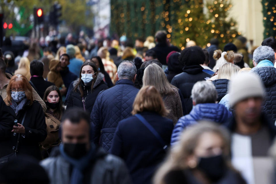 Image: People walk past a Selfridge's store on Oxford Street, amid the COVID-19 outbreak in London (Henry Nicholls / Reuters)