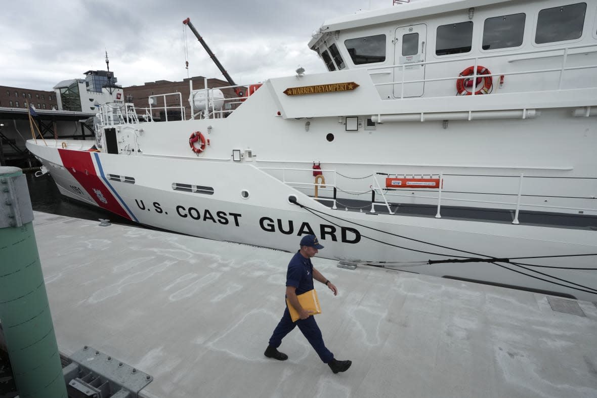 FILE – The U.S. Coast Guard Cutter Warren Deyampert is docked as a member of the Coast Guard walks past, Tuesday, June 20, 2023, at Coast Guard Base Boston, in Boston. Rescuers are racing against time to find the missing submersible carrying five people, who were reported overdue Sunday night, June 18, 2023. (AP Photo/Steven Senne, File)