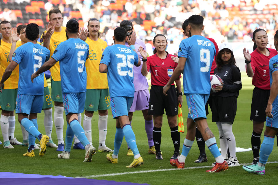 Referee Yamashita Yoshimi of Japan, center, is seen before the Asian Cup Group B soccer match between Australia and India at Ahmad Bin Ali Stadium in Doha, Qatar, Saturday, Jan. 13, 2024. (AP Photo/Aijaz Rahi)