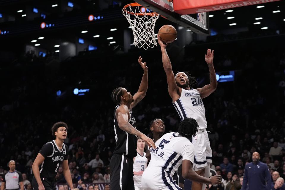 Memphis Grizzlies' Lamar Stevens, right, shoots over Brooklyn Nets' Nic Claxton during the second half of an NBA basketball game, Monday, March 4, 2024, in New York. (AP Photo/Frank Franklin II)