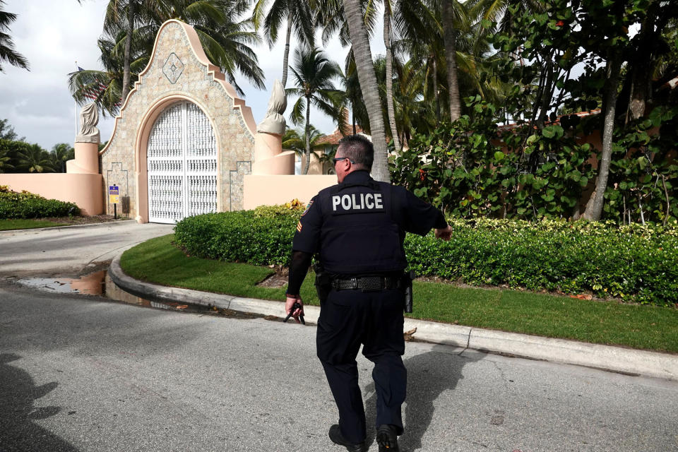 A police officer outside of Mar-a-Lago in West Palm Beach, Fla,, on Aug. 9, 2022, following a FBI search of Donald Trump's estate.
