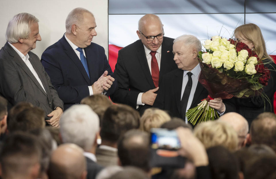 Leader of Poland's ruling party Jaroslaw Kaczynski ,right, and party activists react to exit poll results right after voting closed in the nation's parliamentary election that is seen crucial for the nation's course in the next four years, in Warsaw, Poland, on Sunday, Oct. 13 ,2019. (AP Photo)