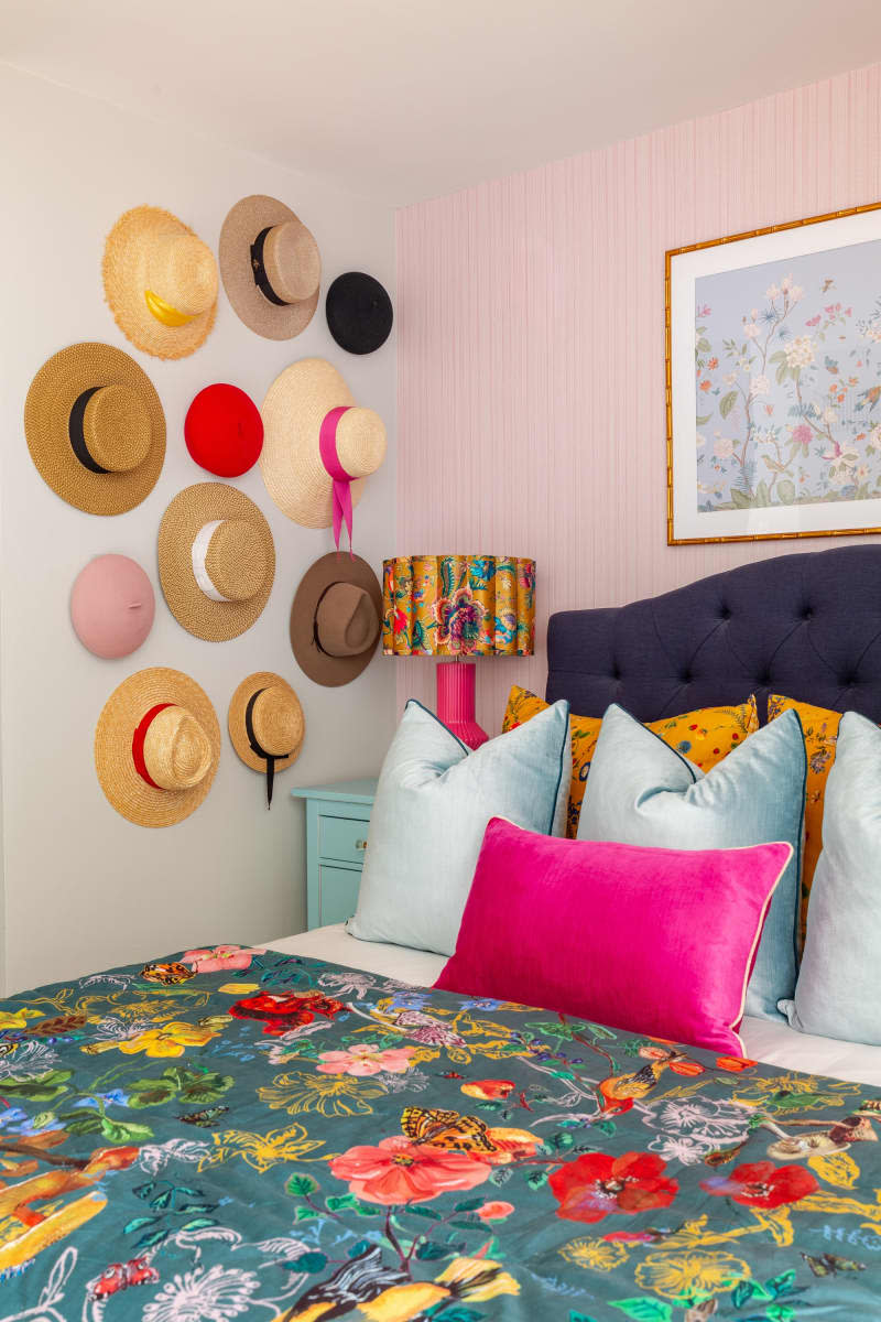 Hats hang as decorations next to a bed