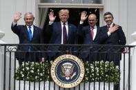 FILE - In this Tuesday, Sept. 15, 2020 file photo, Israeli Prime Minister Benjamin Netanyahu, left, U.S. President Donald Trump, Bahrain Foreign Minister Khalid bin Ahmed Al Khalifa and United Arab Emirates Foreign Minister Abdullah bin Zayed al-Nahyan pose for a photo on the Blue Room Balcony after signing the Abraham Accords during a ceremony on the South Lawn of the White House in Washington. Saudi Arabia insists officially that there can be no formal ties with Israel before Palestinian statehood is achieved, but state-backed media and clerics have softened their tone toward Jews and there has been no official condemnation or criticism of the deals signed by the UAE or Bahrain with Israel. (AP Photo/Alex Brandon, File)