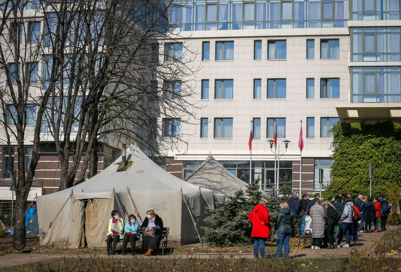 Protesters hold a rally in front of the Park Inn hotel housing OSCE monitor mission in the rebel-controlled city of Donetsk